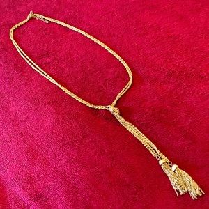 Gold tone necklace with drop tassel accent